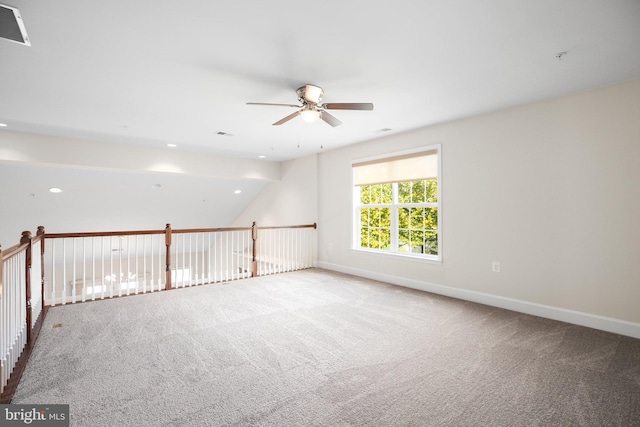 spare room with lofted ceiling, carpet flooring, and ceiling fan