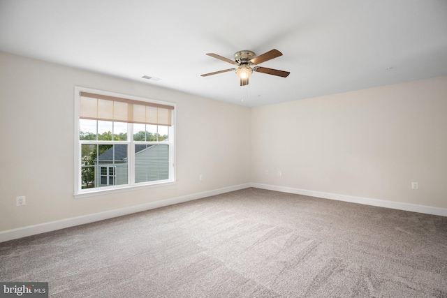 spare room featuring ceiling fan and carpet