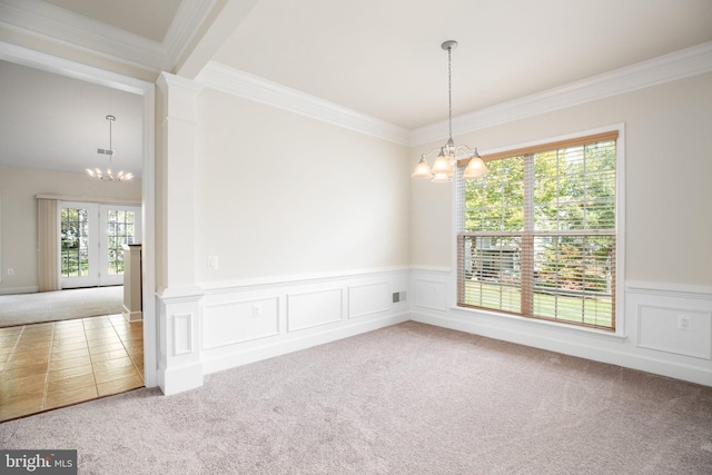 carpeted empty room with a chandelier, plenty of natural light, and crown molding