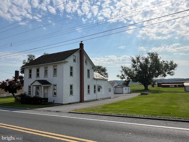 view of front of house featuring a garage and a front lawn