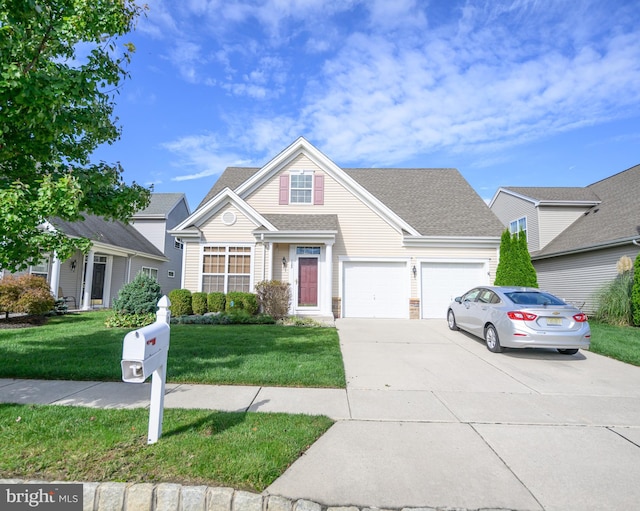 view of front of property with a front lawn and a garage