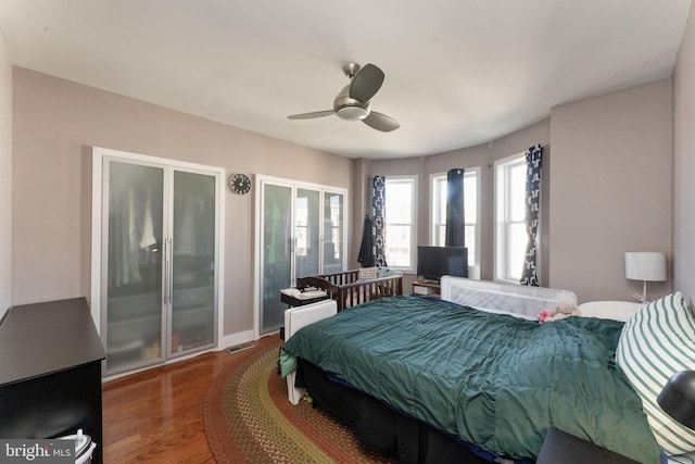 bedroom featuring access to outside, hardwood / wood-style flooring, and ceiling fan