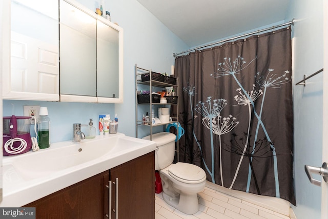 bathroom with vanity, a shower with curtain, toilet, and tile patterned flooring