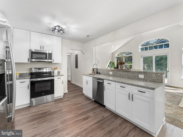 kitchen featuring dark hardwood / wood-style floors, white cabinetry, and appliances with stainless steel finishes