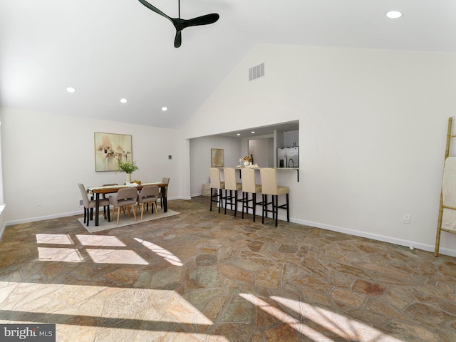 dining room featuring ceiling fan and high vaulted ceiling