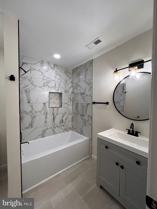 bathroom with shower / tub combination, vanity, and tile walls