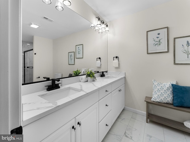 bathroom featuring vanity and a shower with shower door