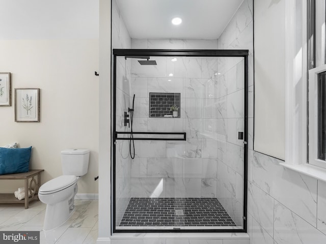 bathroom with toilet and an enclosed shower