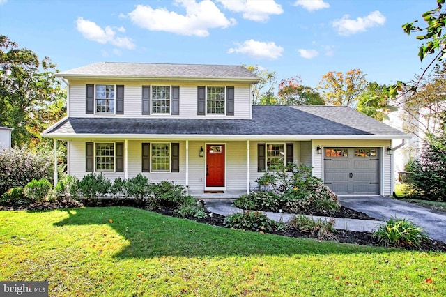 front of property featuring a front lawn, covered porch, and a garage