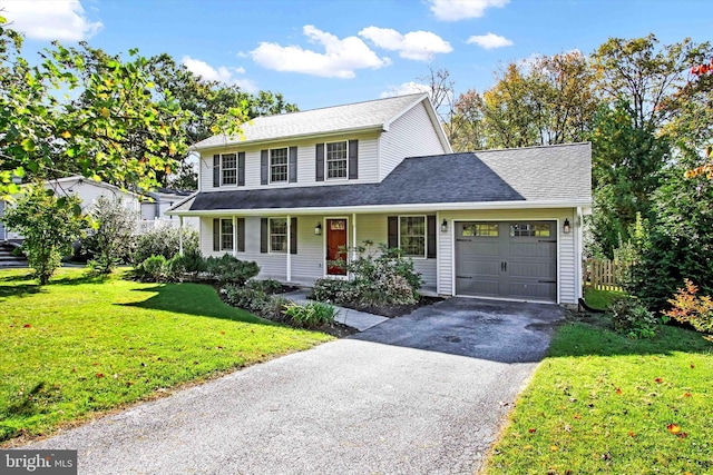 view of front facade featuring a garage, a porch, and a front lawn