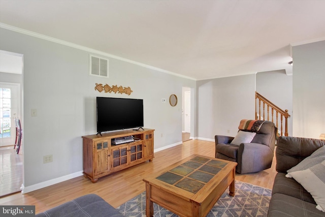 living room featuring ornamental molding and hardwood / wood-style floors