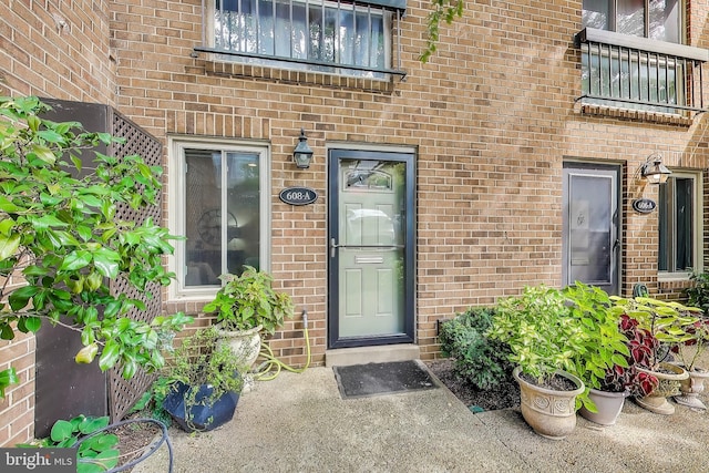 view of exterior entry with brick siding