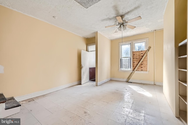 unfurnished bedroom featuring a textured ceiling and ceiling fan