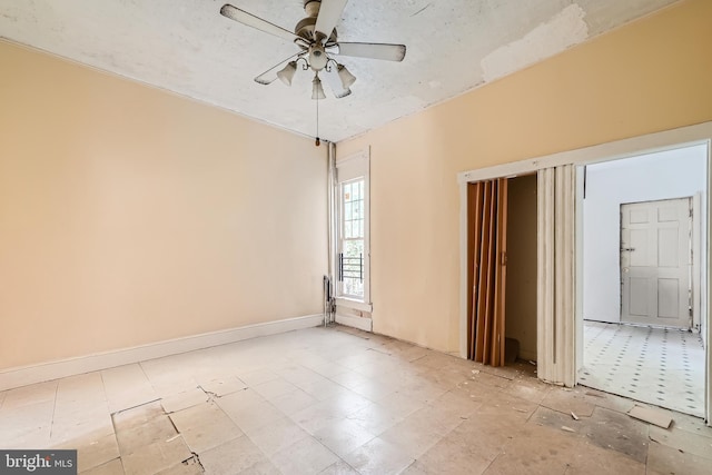 unfurnished room with ceiling fan