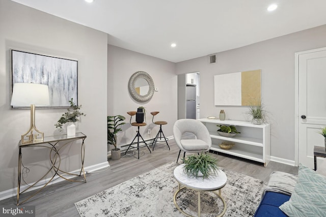 sitting room with hardwood / wood-style floors