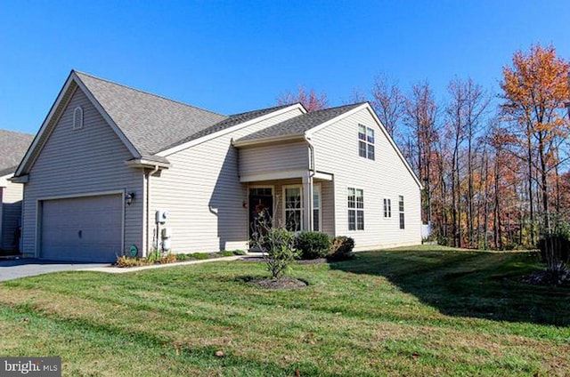 view of front of house featuring a garage and a front lawn