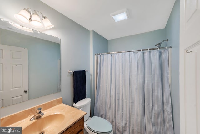 bathroom with vanity, a shower with shower curtain, and toilet