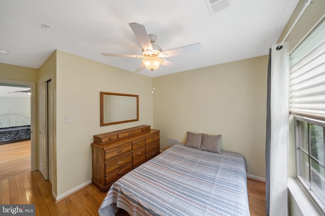 bedroom featuring a closet, light wood-type flooring, and ceiling fan