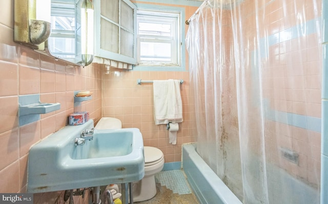 bathroom with shower / bath combo, tile patterned floors, tile walls, and toilet