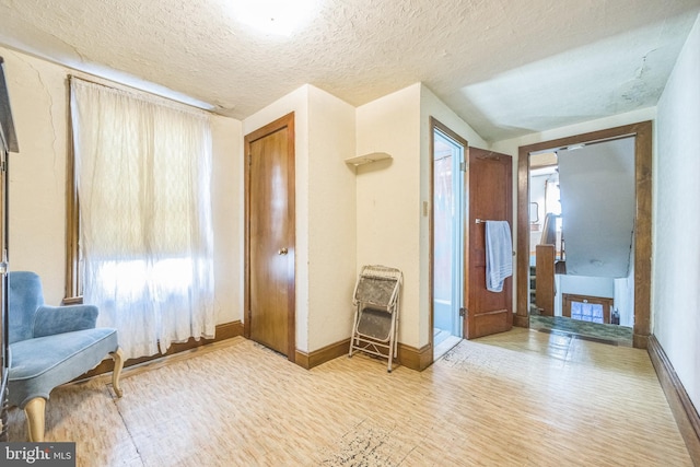 foyer featuring a textured ceiling and hardwood / wood-style floors