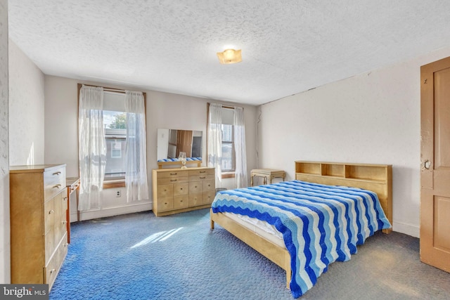 bedroom featuring carpet floors and a textured ceiling