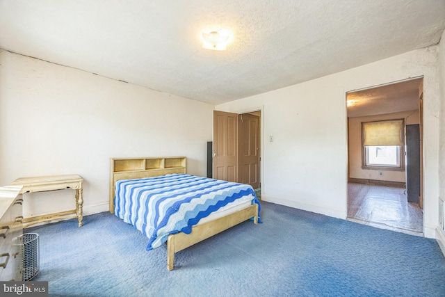 bedroom with carpet and a textured ceiling