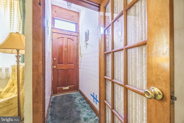 entryway with dark colored carpet