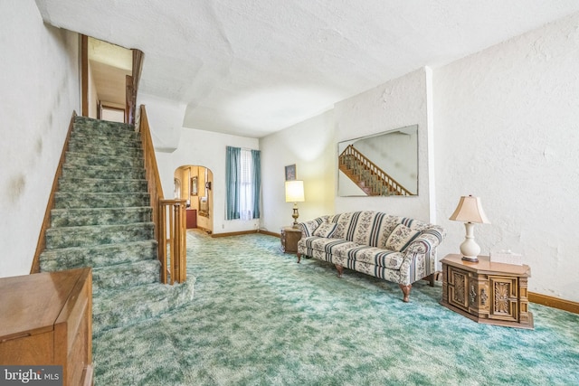 carpeted living room featuring a textured ceiling