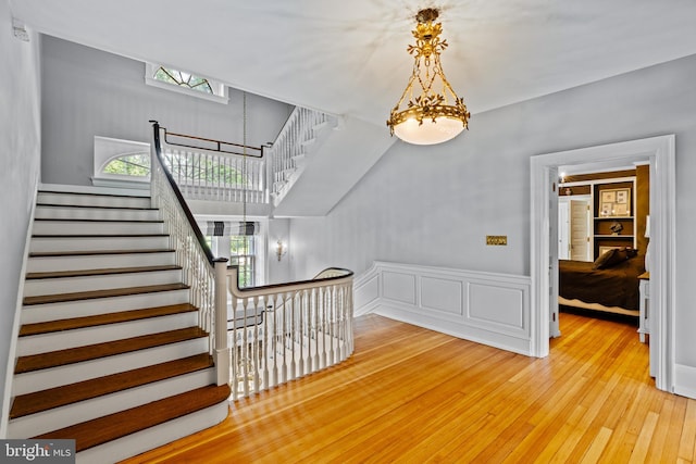 stairs with a wealth of natural light and hardwood / wood-style floors