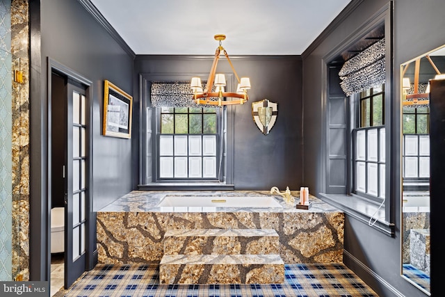 entrance foyer featuring crown molding and an inviting chandelier