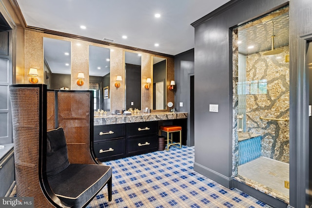 bathroom with walk in shower, vanity, crown molding, and tile patterned floors