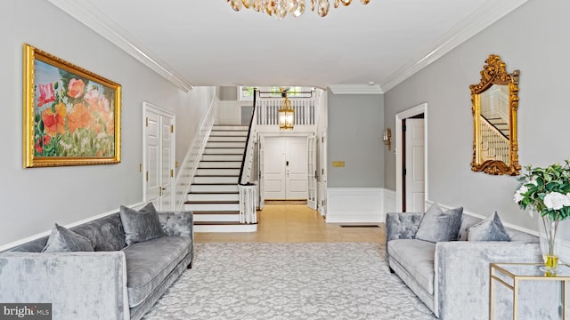 living room with crown molding and a chandelier