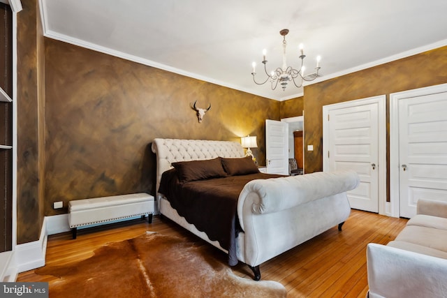 bedroom featuring ornamental molding, hardwood / wood-style flooring, and a notable chandelier