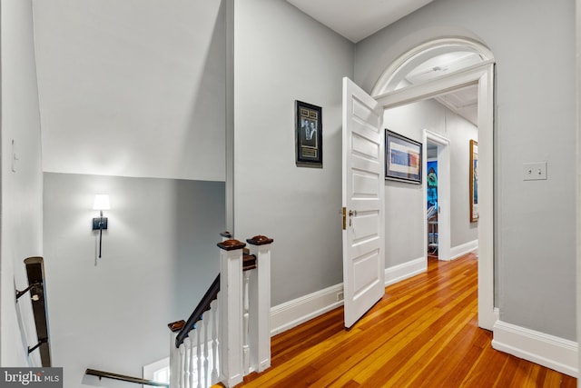 hallway with hardwood / wood-style floors