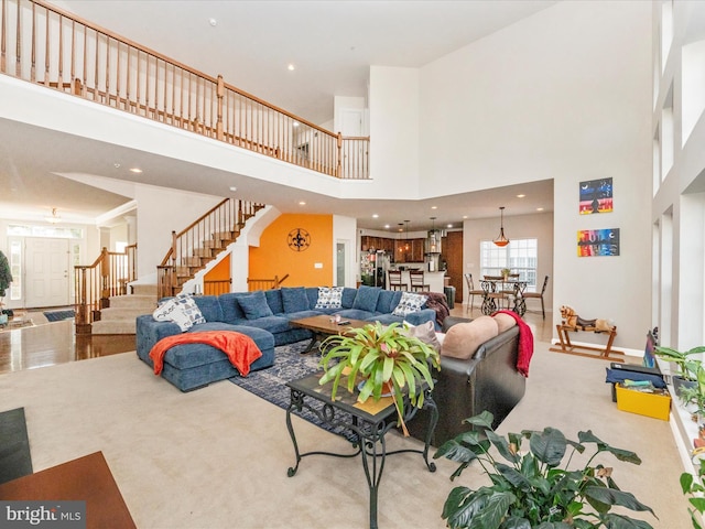 living room featuring light hardwood / wood-style floors and a towering ceiling