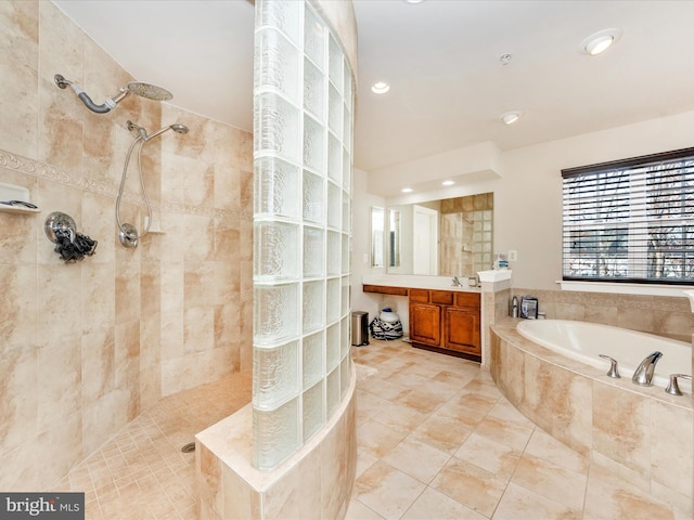 bathroom featuring vanity and separate shower and tub