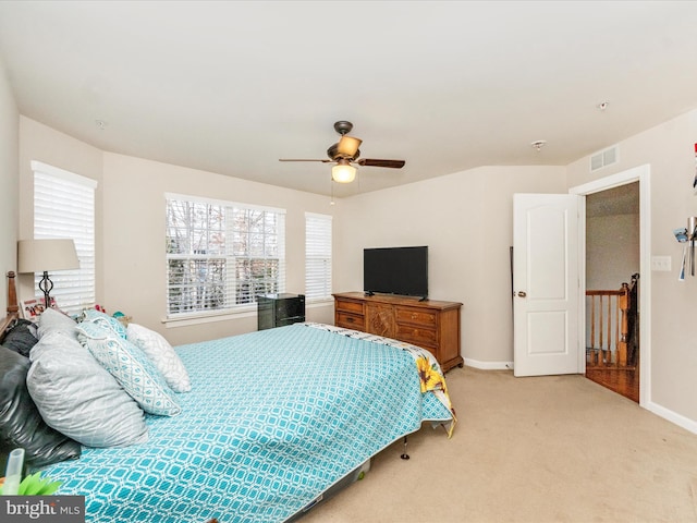 bedroom with ceiling fan and light colored carpet