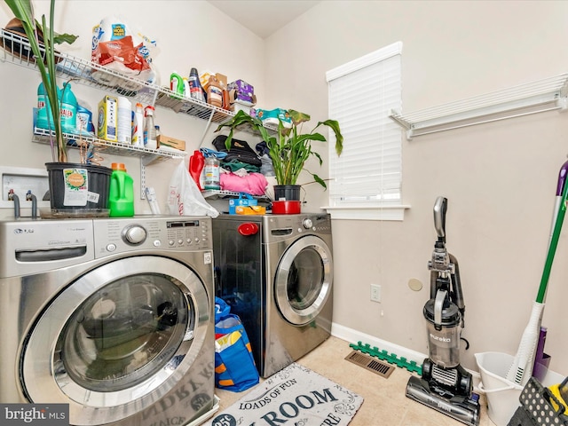 clothes washing area with washing machine and dryer