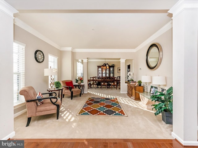 living area with a wealth of natural light, crown molding, and wood-type flooring