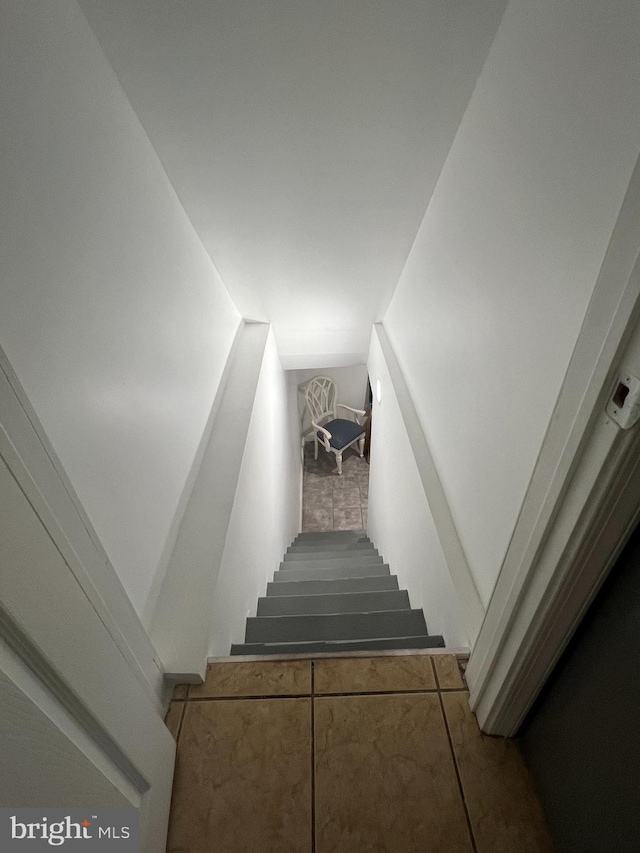 stairway featuring vaulted ceiling