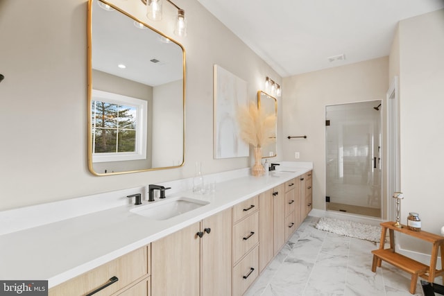 bathroom featuring vanity and a shower with shower door