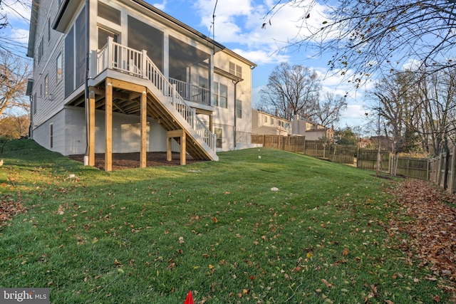 back of property featuring a lawn and a sunroom