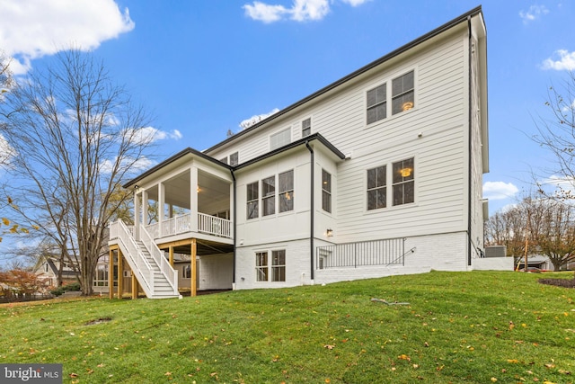 rear view of property with a lawn