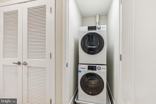 laundry room with stacked washer / dryer