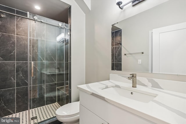 bathroom featuring vanity, toilet, and an enclosed shower