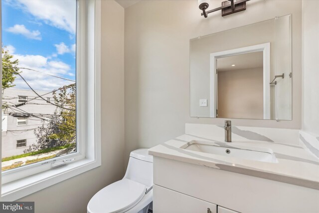 bathroom with toilet and vanity