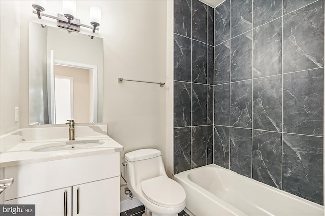 full bathroom with tiled shower / bath, vanity, and toilet