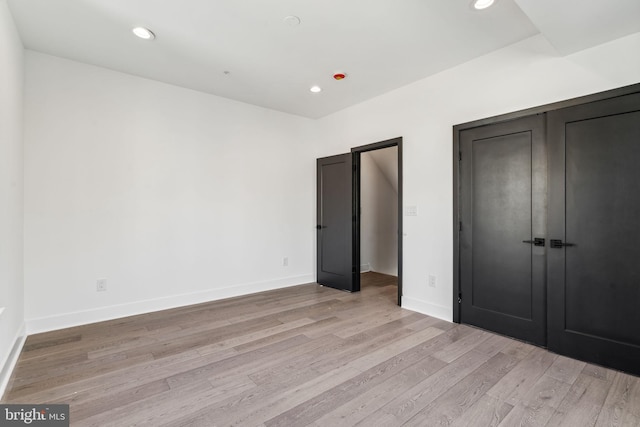 unfurnished bedroom with light wood-type flooring