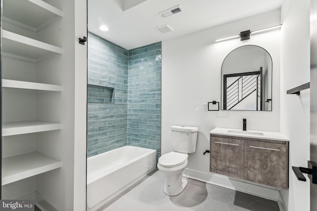 full bathroom featuring tile patterned floors, vanity, toilet, and tiled shower / bath