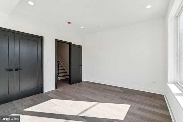 unfurnished bedroom with dark hardwood / wood-style flooring